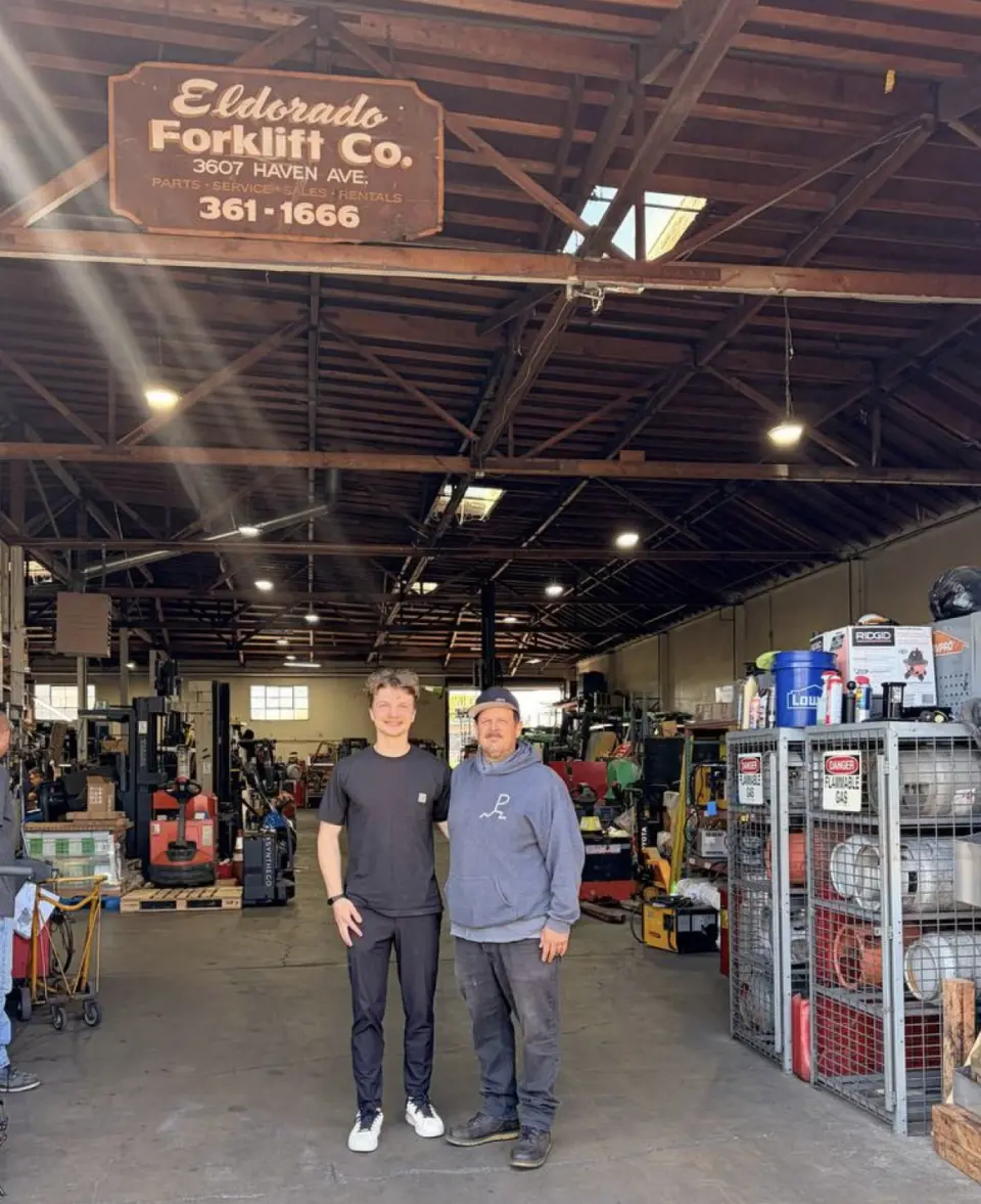 The owner of Eldorado Forklift Co. with our founder, under the shop's original sign