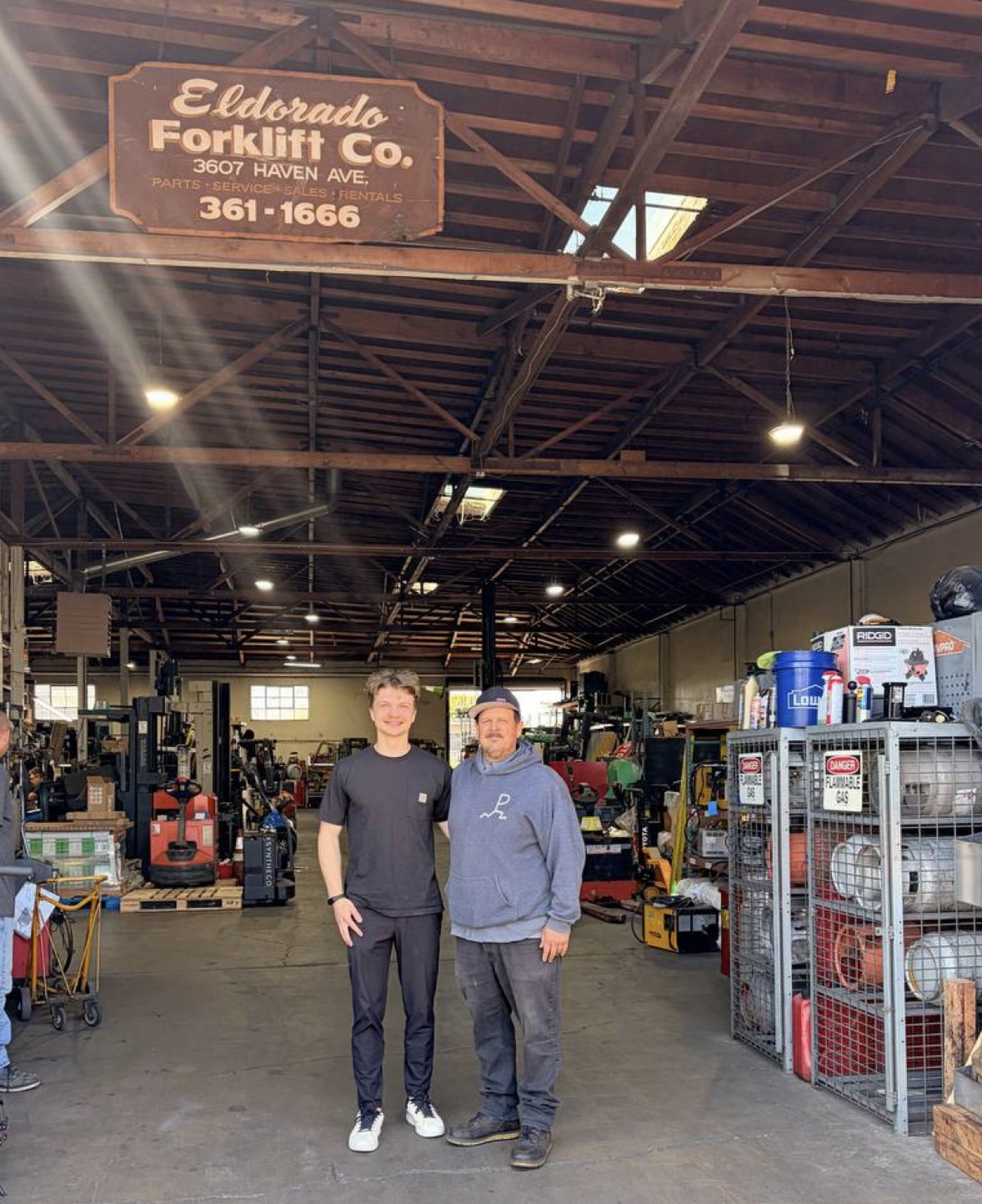 The owner of Eldorado Forklift Co. with our founder, under the shop's original sign